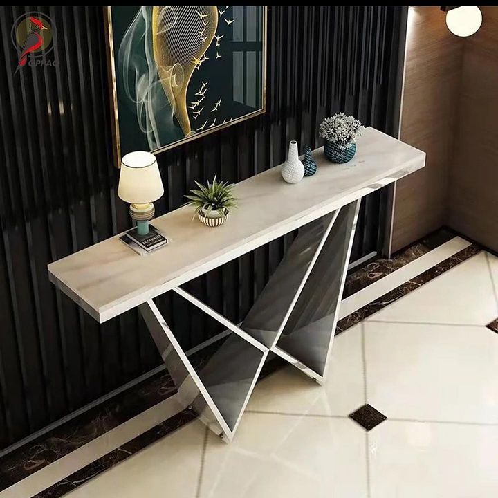 This luxurious sintered stone-top console table features a sleek and modern design with glamorous gold accents. With a striking geometric pattern and oval base, this table adds impeccable style to any space. Crafted with a durable and easy-to-clean sintered stone top, this console table offers ample room to display decor pieces while keeping your space clutter-free. Its sturdy gold frame and base ensure long-lasting durability, making it a staple piece in your home. (M)